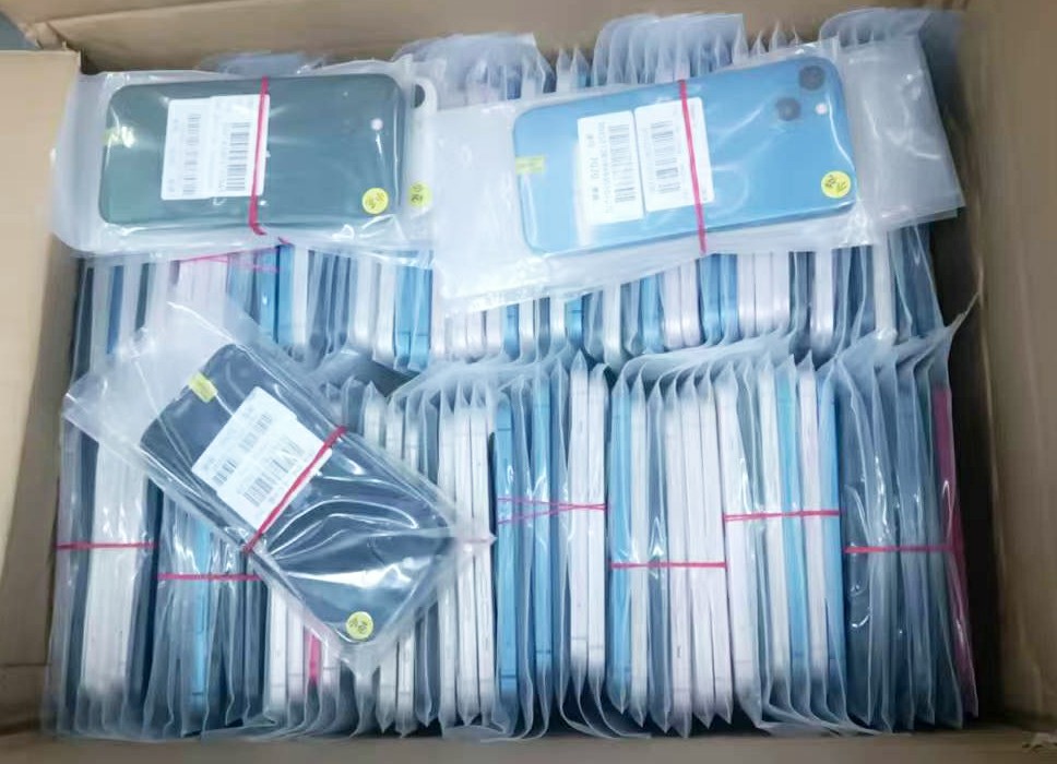 Bulk wholesale iPhone units undergoing sourcing and quality inspection at a B2B warehouse